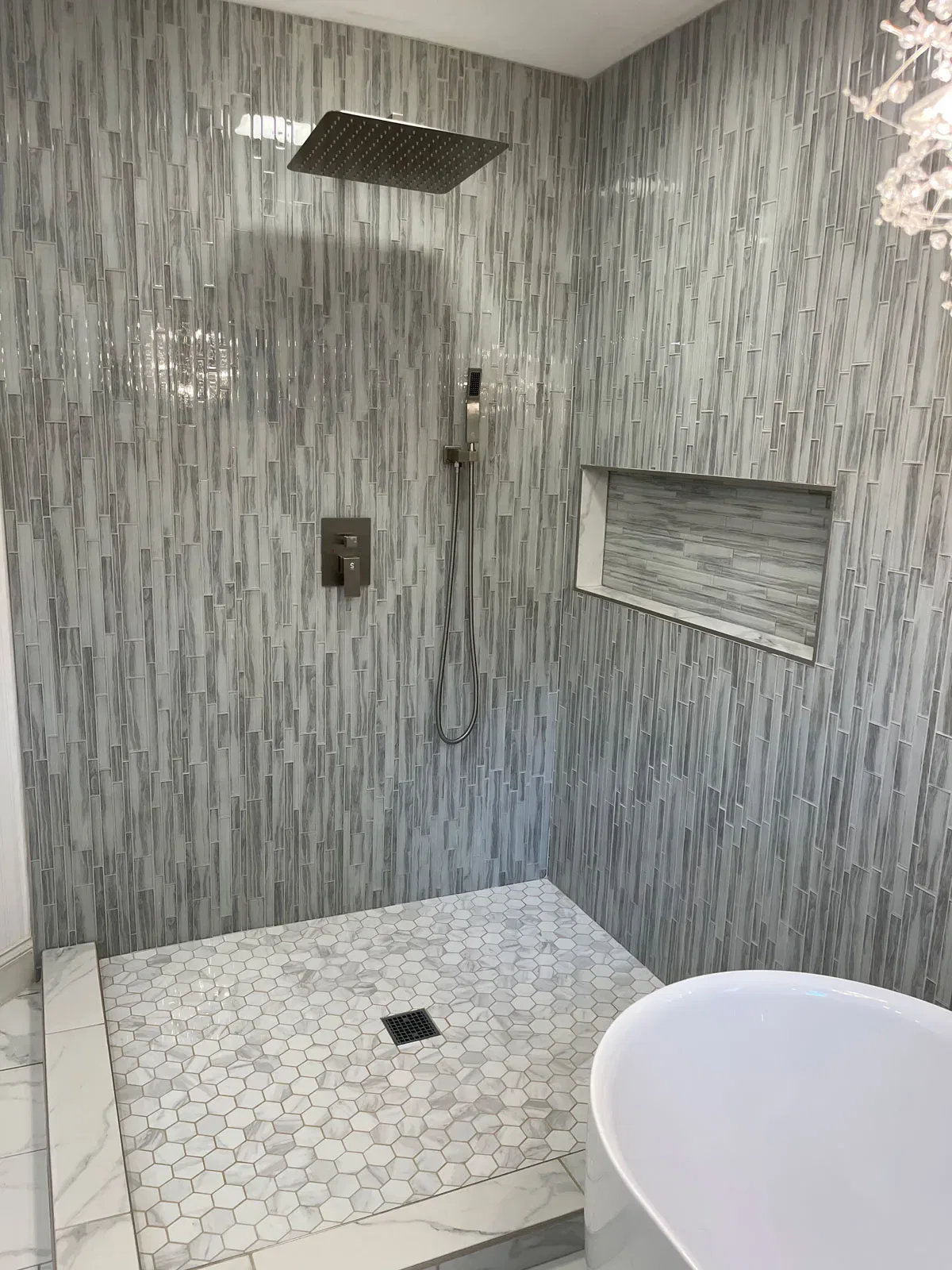 Modern bathroom with tiled shower and freestanding tub